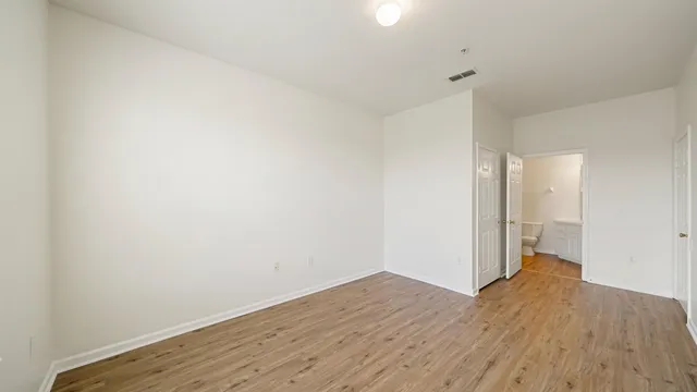 a view of a room with wooden floor