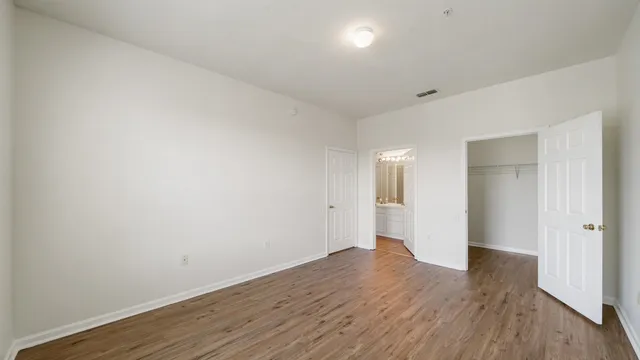 a view of an empty room with wooden floor