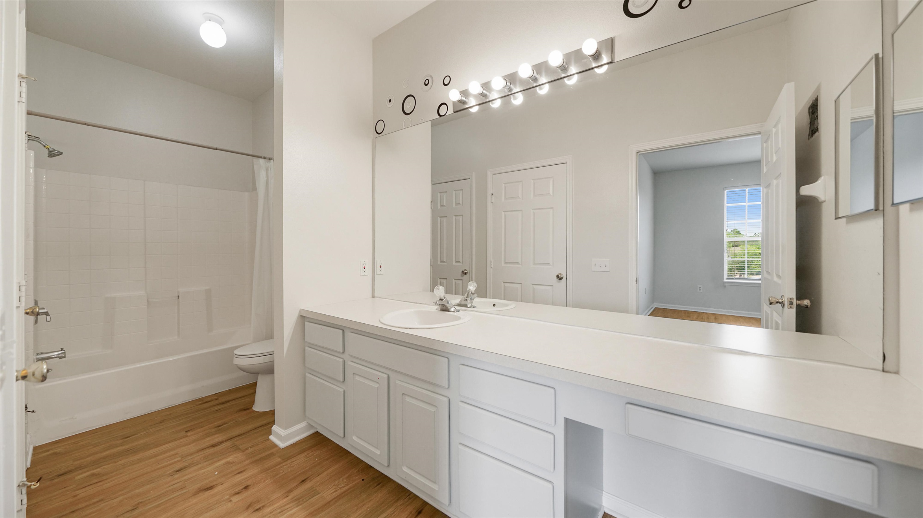 7990 Baymeadows Road, Unit 1114 Jacksonville, FL 32256 - Photo 15 of 30 a spacious bathroom with a double vanity sink a large mirror and a shower