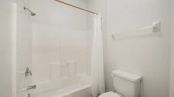 a bath room with a toilet and a bath tub