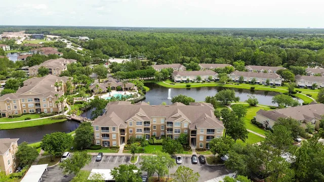 an aerial view of a house with a garden and lake view