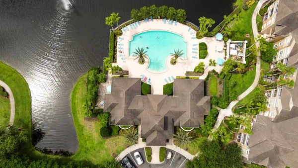 an aerial view of a house with a swimming pool