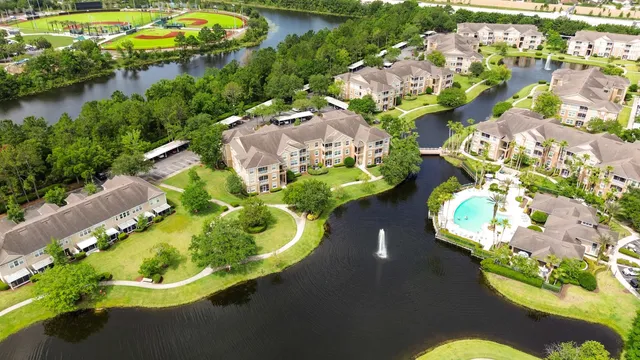 an aerial view of a house a yard and a swimming pool