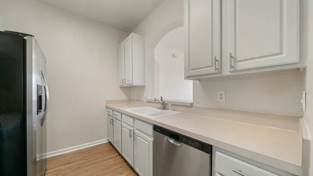a kitchen with a sink and a refrigerator