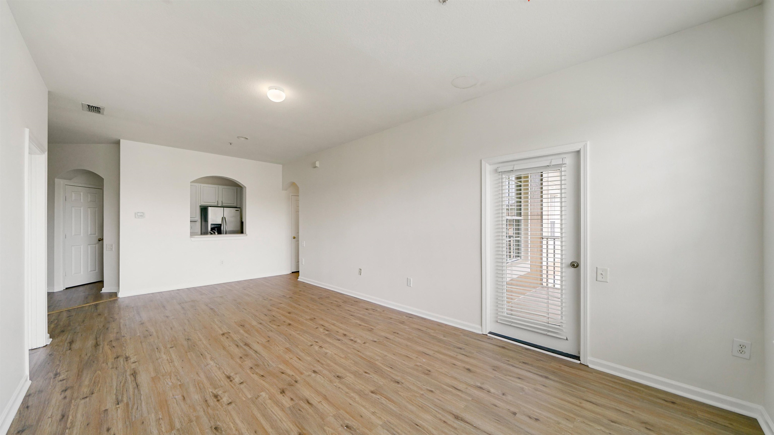 7990 Baymeadows Road, Unit 1114 Jacksonville, FL 32256 - Photo 9 of 30 wooden floor in an empty room with a window