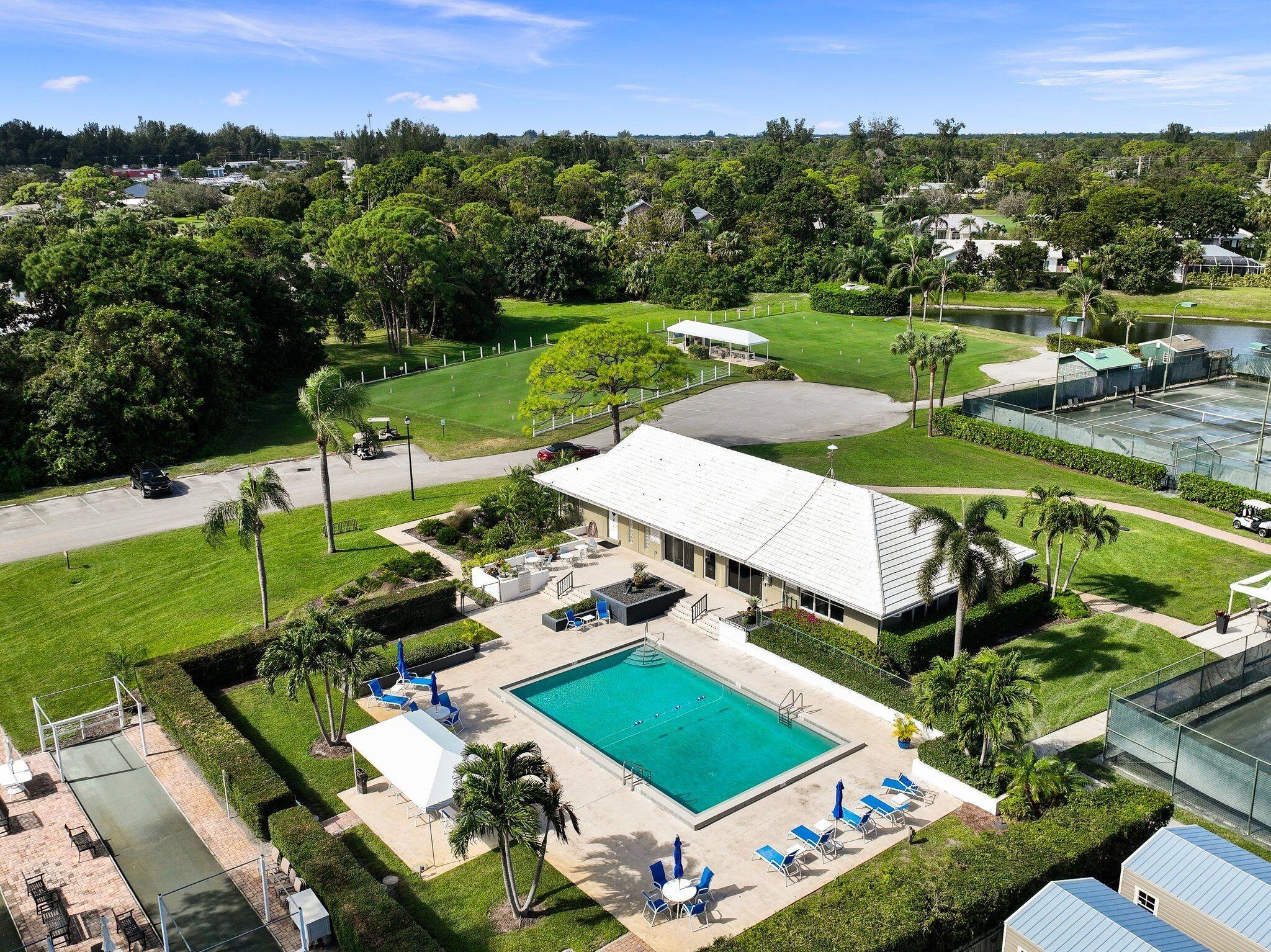 3374 Southeast Fairway East Stuart, FL 34997 - Photo 54 of 65 an aerial view of a house with a garden and pool