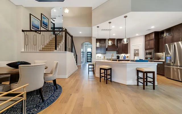 a open kitchen with dining table and chairs