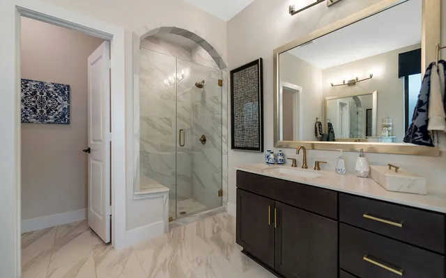 a bathroom with a double vanity sink mirror and shower