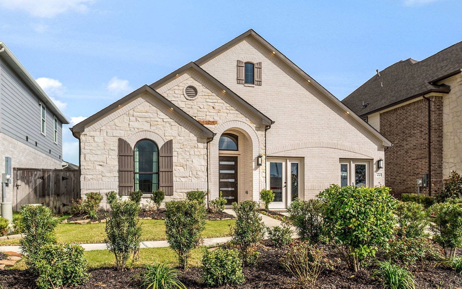 3610 Compass Pointe Court Angleton, TX 77515 - Photo 2 of 27 a view of a white house with large windows and flower plants