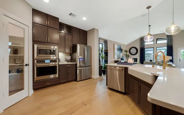 a kitchen with a sink stainless steel appliances and cabinets