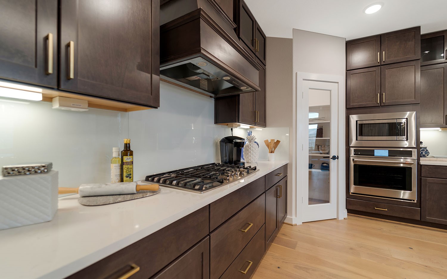 3610 Compass Pointe Court Angleton, TX 77515 - Photo 7 of 27 a kitchen with stainless steel appliances a stove a refrigerator and cabinets