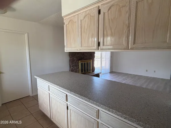 a kitchen with granite countertop white cabinets and a white stove