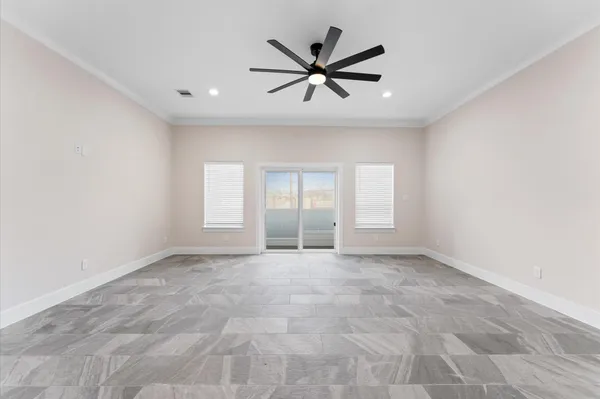 a view of a livingroom with a ceiling fan and window