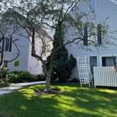 a front view of a house with a garden