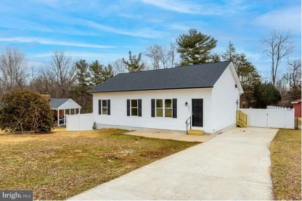 a house that has a tree in front of it