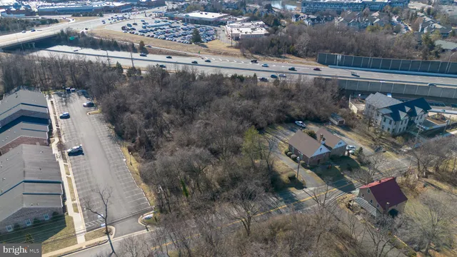 an aerial view of residential houses with city view