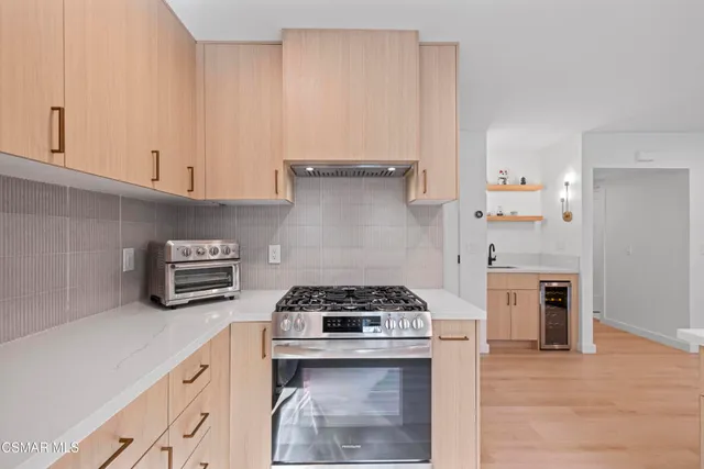 a kitchen with granite countertop a stove and a refrigerator