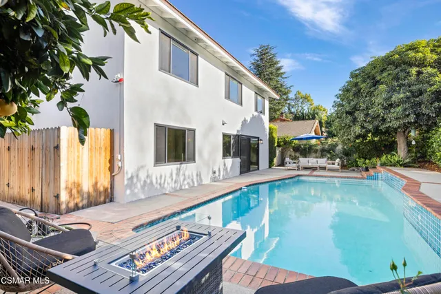 a balcony with table and chairs