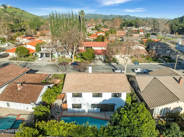 an aerial view of residential houses with outdoor space and street view