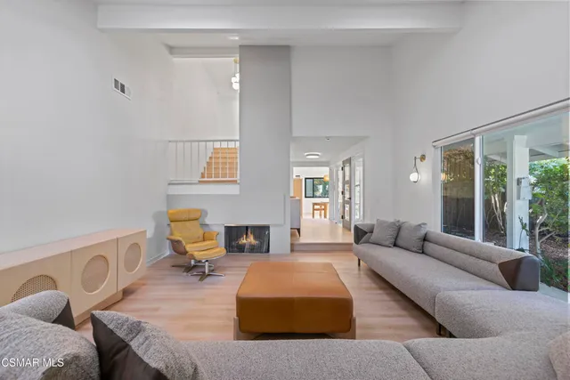 a living room with furniture wooden floor and a fireplace