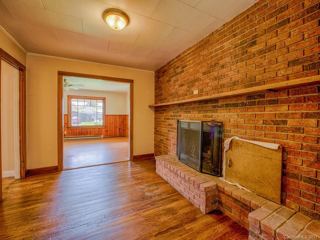 277 Chelsea Road Waynesville, NC 28786 - Photo 11 of 18 a view of a hallway with wooden floor and a bathroom