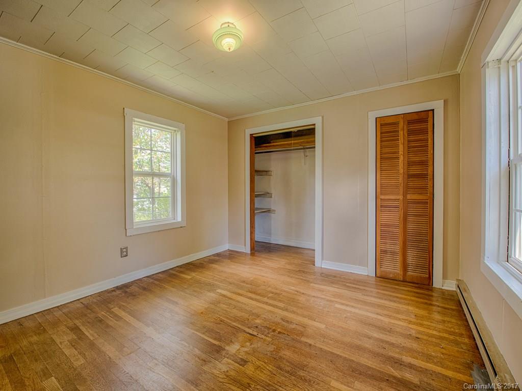 277 Chelsea Road Waynesville, NC 28786 - Photo 16 of 18 an empty room with closet and windows