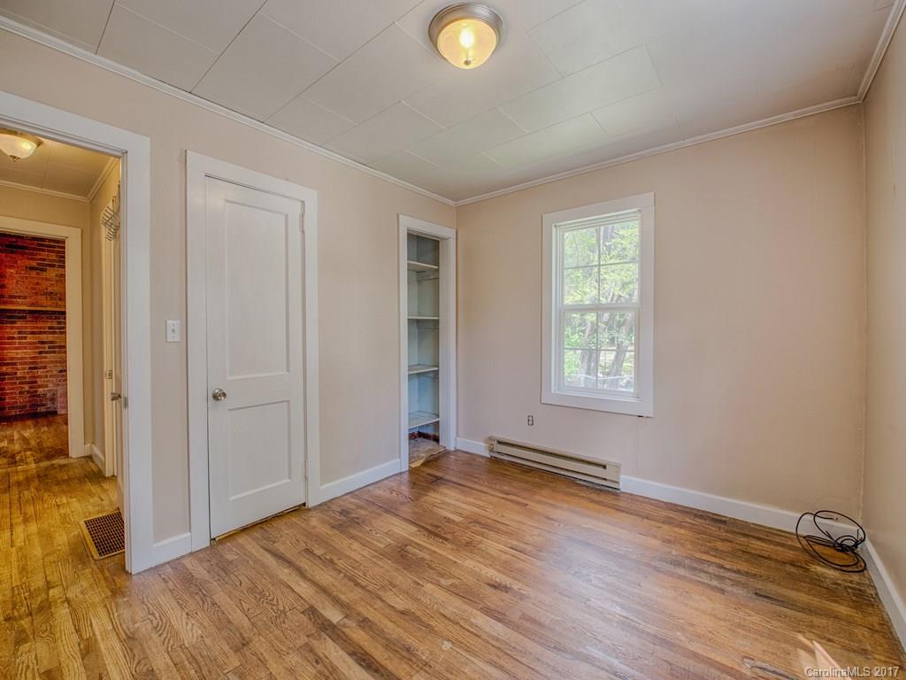 277 Chelsea Road Waynesville, NC 28786 - Photo 17 of 18 a view of an empty room with window and wooden floor