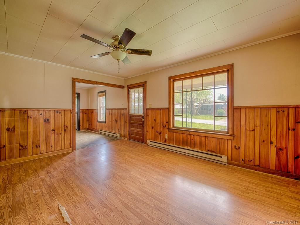 277 Chelsea Road Waynesville, NC 28786 - Photo 7 of 18 a view of an empty room with a window and wooden floor