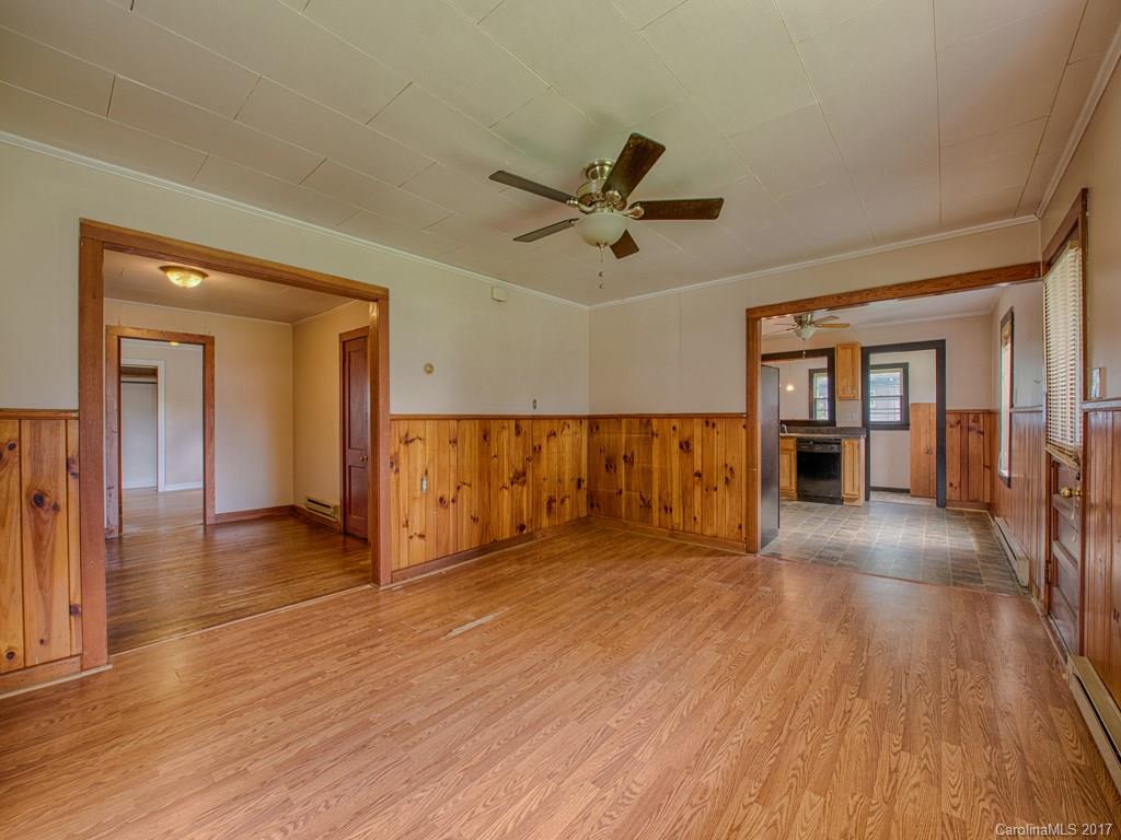 277 Chelsea Road Waynesville, NC 28786 - Photo 8 of 18 a view of a livingroom with wooden floor and a ceiling fan