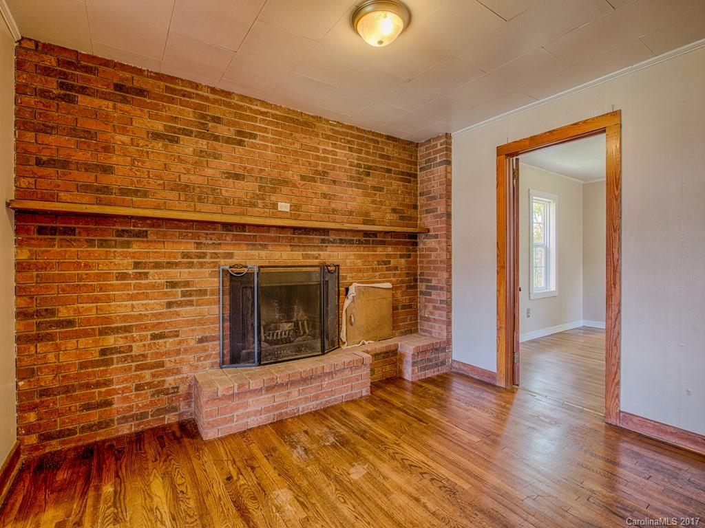 277 Chelsea Road Waynesville, NC 28786 - Photo 10 of 18 a view of a livingroom with wooden floor and a fireplace