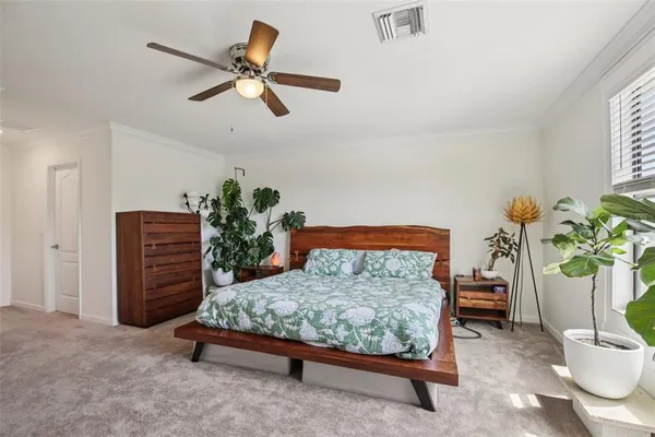a bedroom with a bed and a potted plant