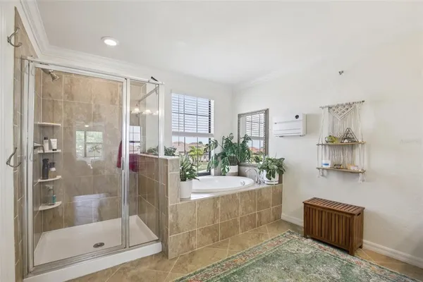 a bathroom with a tub shower sink and mirror