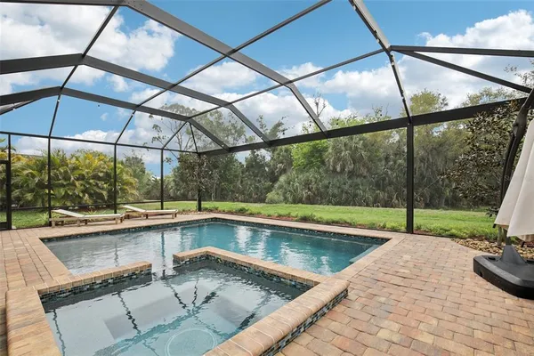a view of a backyard and swimming pool