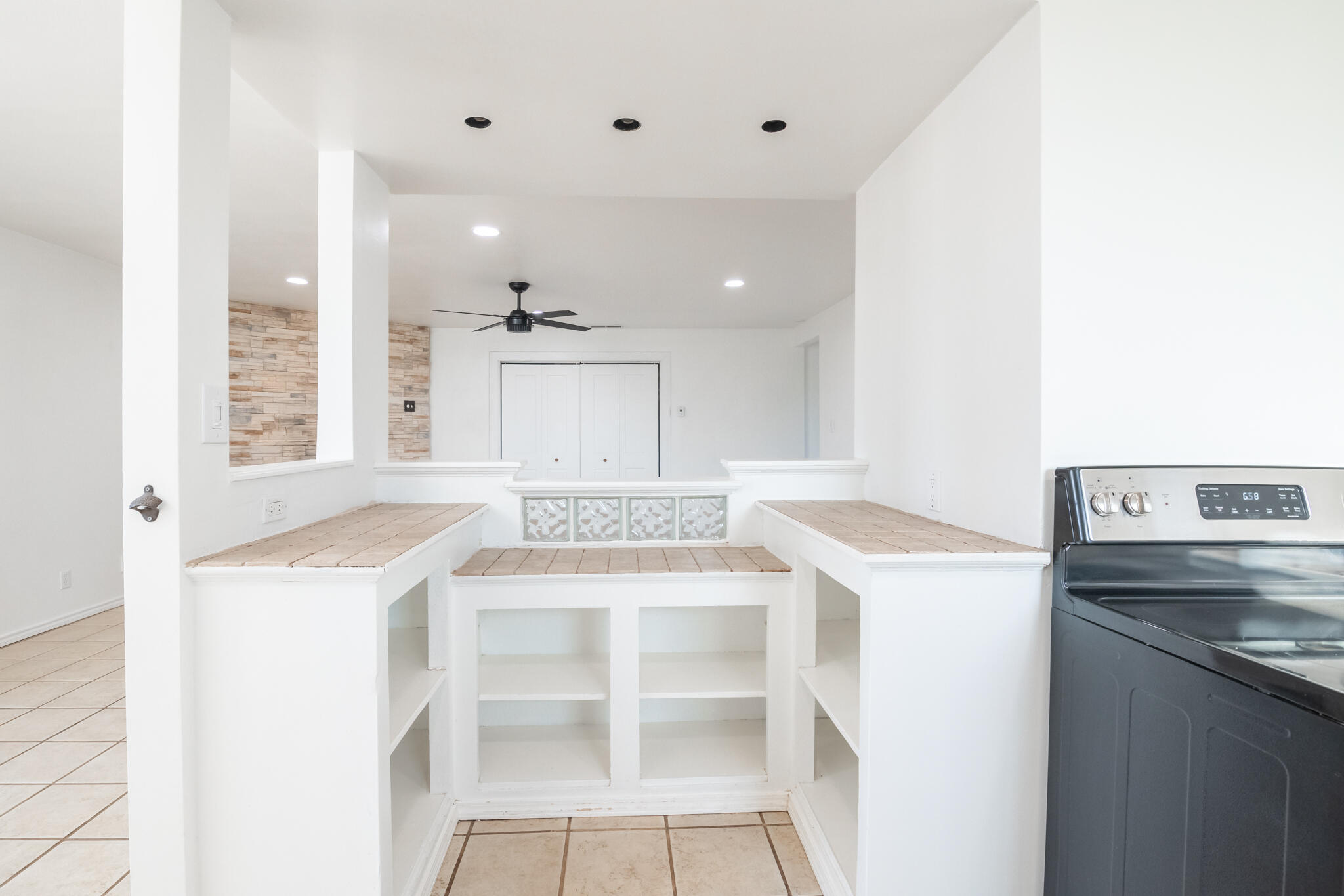 6917 Highway 114 Lubbock, TX 79407 - Photo 21 of 45 a kitchen with a stove a sink and a refrigerator