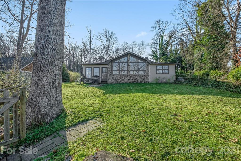 13914 Point Lookout Road Charlotte, NC 28278 - Photo 2 of 41 a view of a big yard with plants and large trees