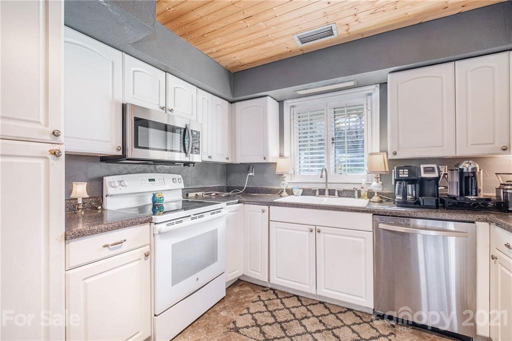 13914 Point Lookout Road Charlotte, NC 28278 - Photo 12 of 41 a kitchen with white cabinets appliances a sink and a window