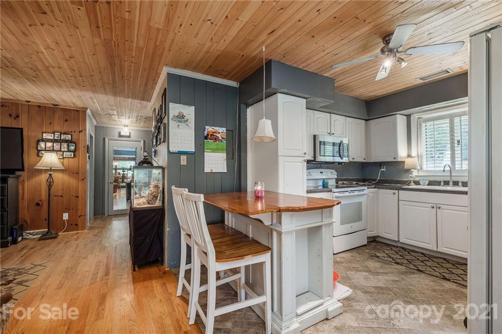 13914 Point Lookout Road Charlotte, NC 28278 - Photo 14 of 41 a kitchen with stainless steel appliances kitchen island granite countertop a refrigerator and microwave