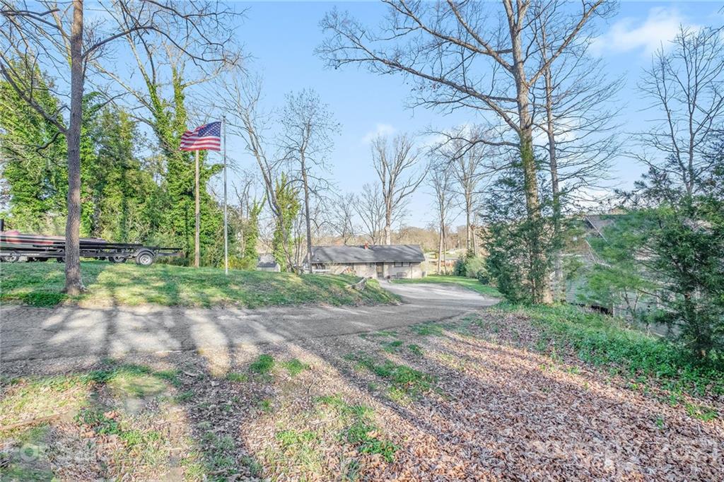 13914 Point Lookout Road Charlotte, NC 28278 - Photo 31 of 41 a view of a yard with plants and trees