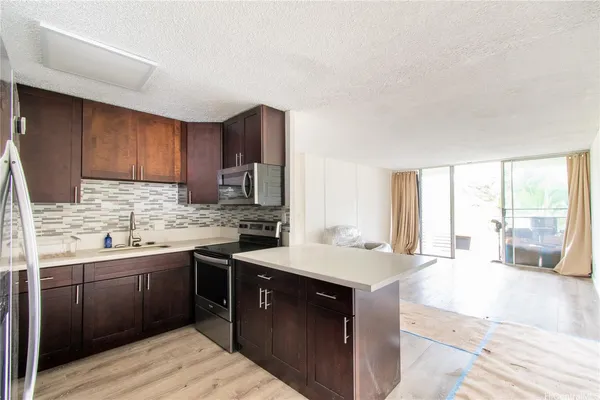 a kitchen with a sink stove and cabinets