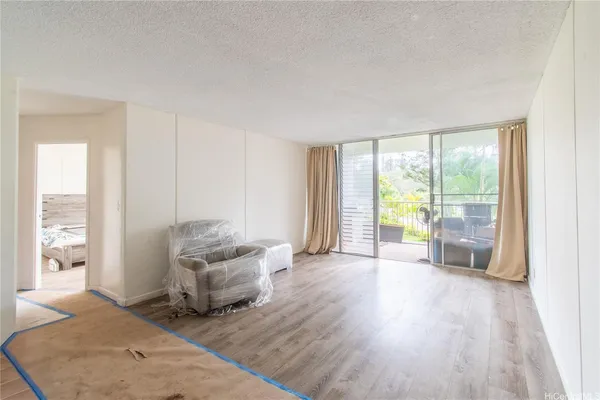 a living room with furniture and large windows