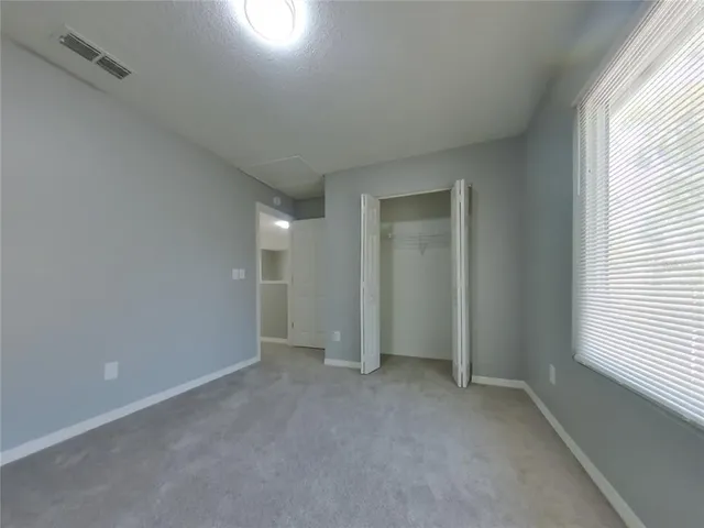 an empty room with a empty space and windows