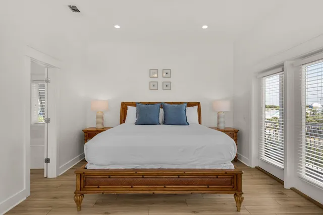 a bedroom with a large bed and a flat screen tv