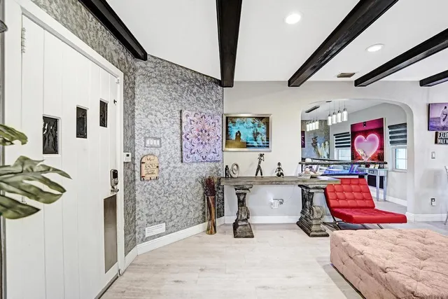 a bedroom with furniture and wooden floor