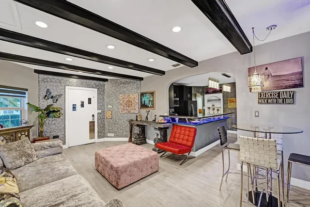 a large living room with stainless steel appliances granite countertop couches a flat screen tv