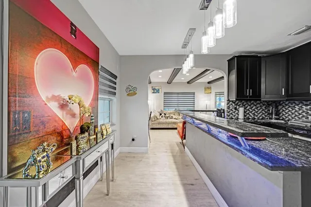 a kitchen with stainless steel appliances granite countertop a refrigerator and a stove