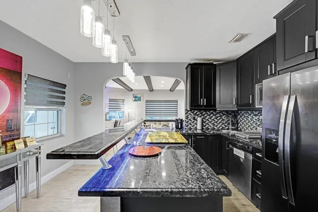 a bathroom with a sink a toilet and shower curtain