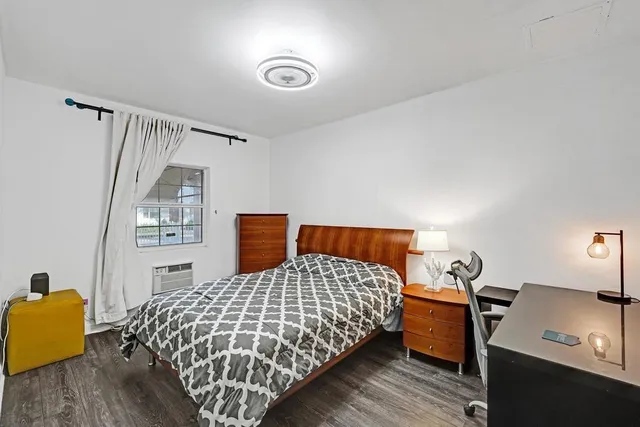 a bedroom with a bed and a painting on the wall