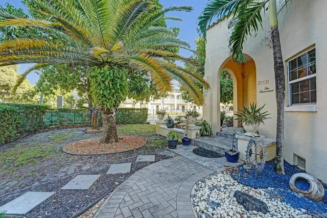 a view of a backyard with large trees
