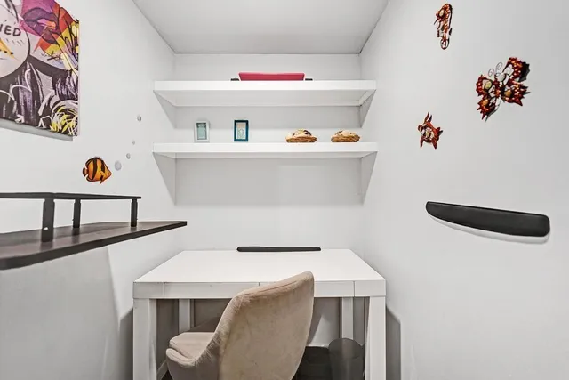 a balcony with furniture and a potted plant