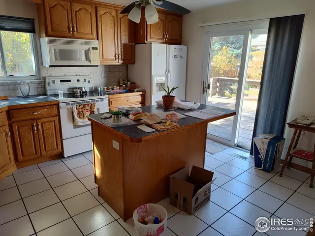 a kitchen with stainless steel appliances granite countertop a stove a sink a refrigerator and a microwave